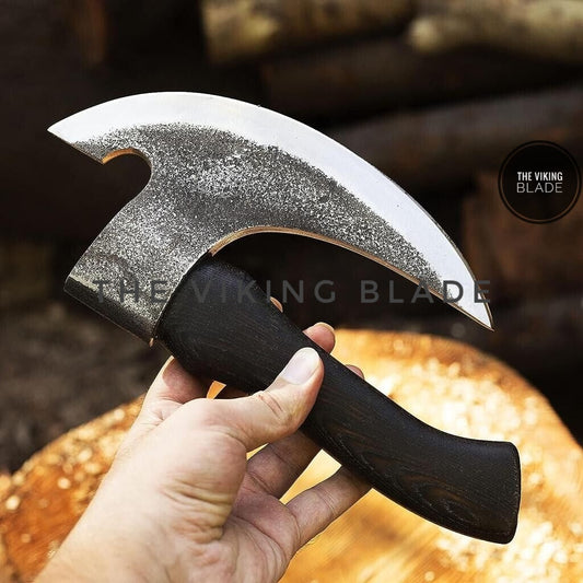 Hand forged Damascus pizza axe with etched blade and ash wood handle.