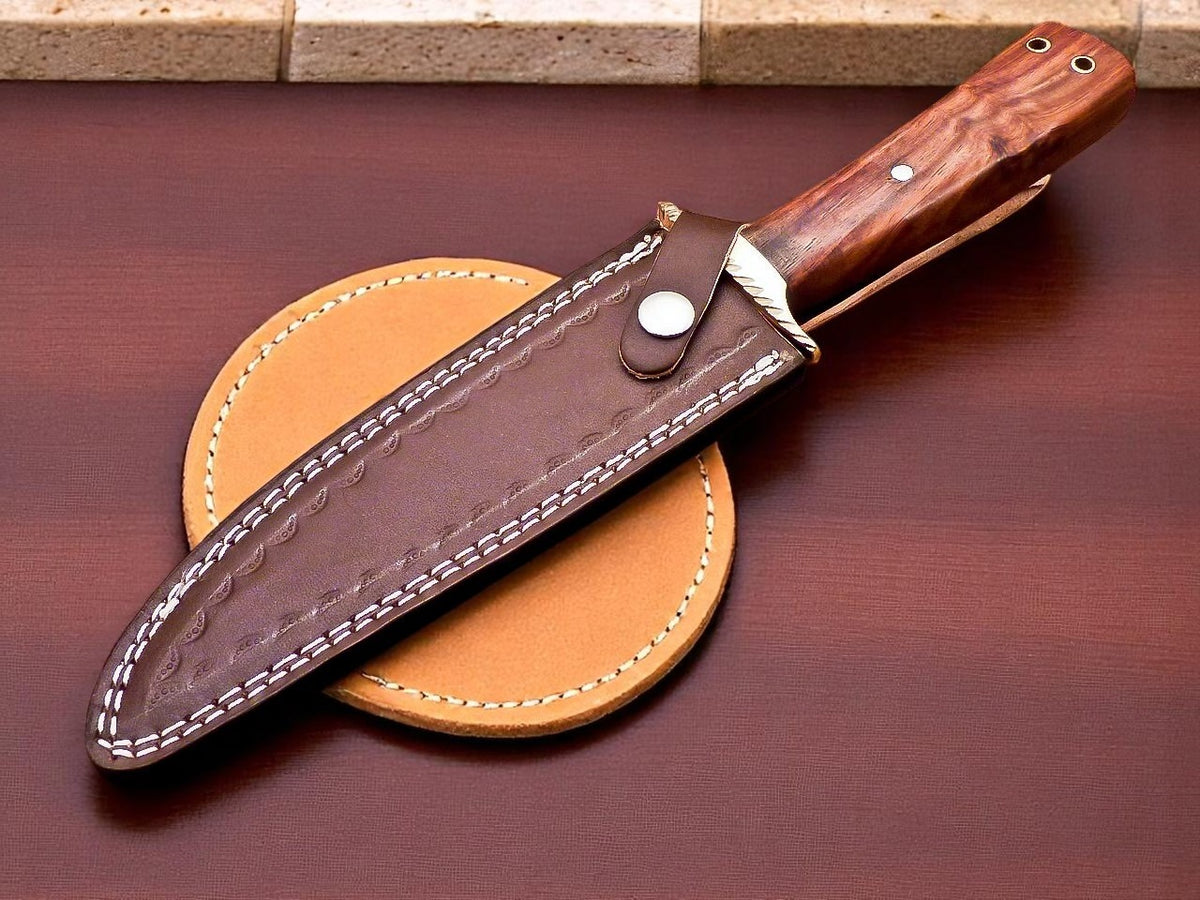 Knife with wooden handle and leather sheath on a dark surface