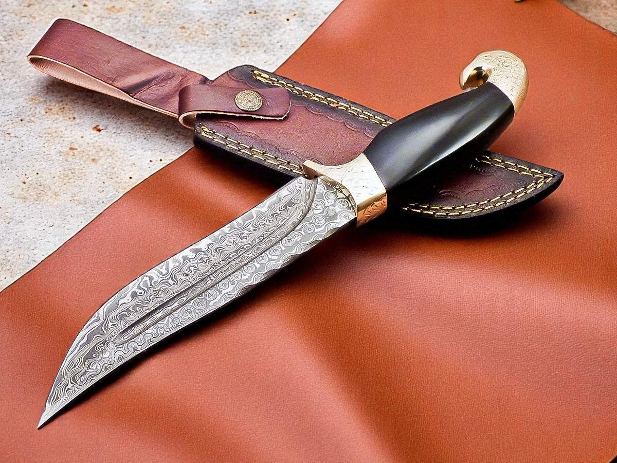 Decorative knife with sheath on brown leather background