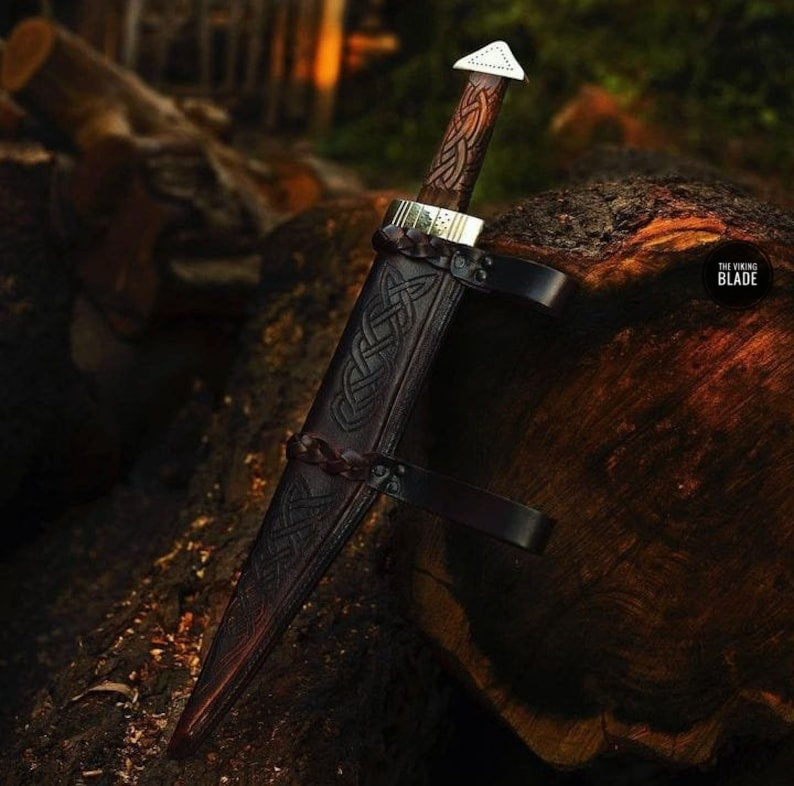 Custom handmade Viking Seax knife with razor-sharp D2 steel blade, hand-engraved rosewood handle, brass guard, and leather sheath.