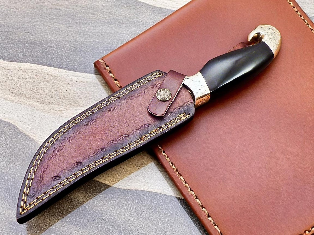 Decorative knife with sheath on textured surface