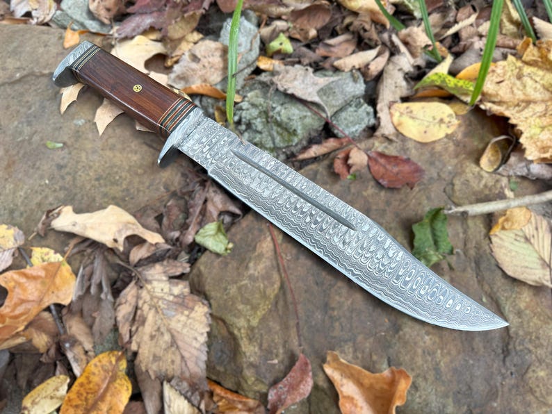 Decorative knife on a background of leaves and rocks