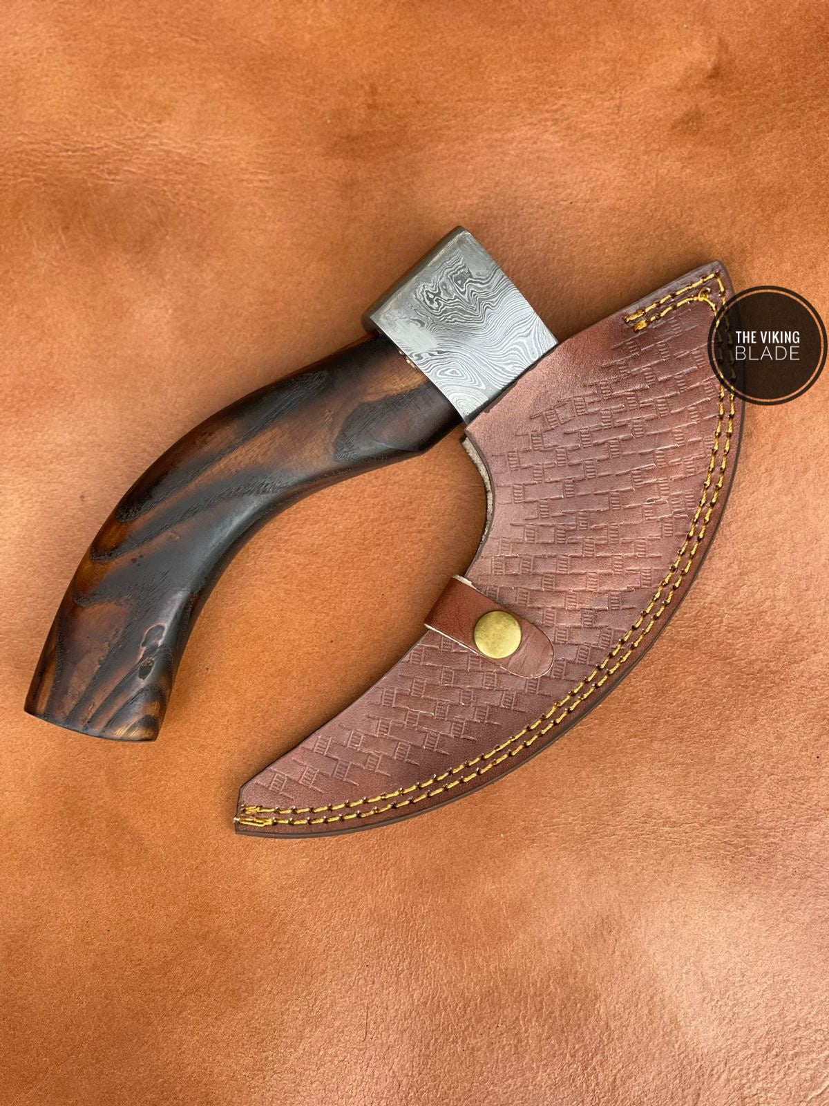Hand forged Damascus axe pizza cutter with leather sheath and wooden handle for safe storage and use.
