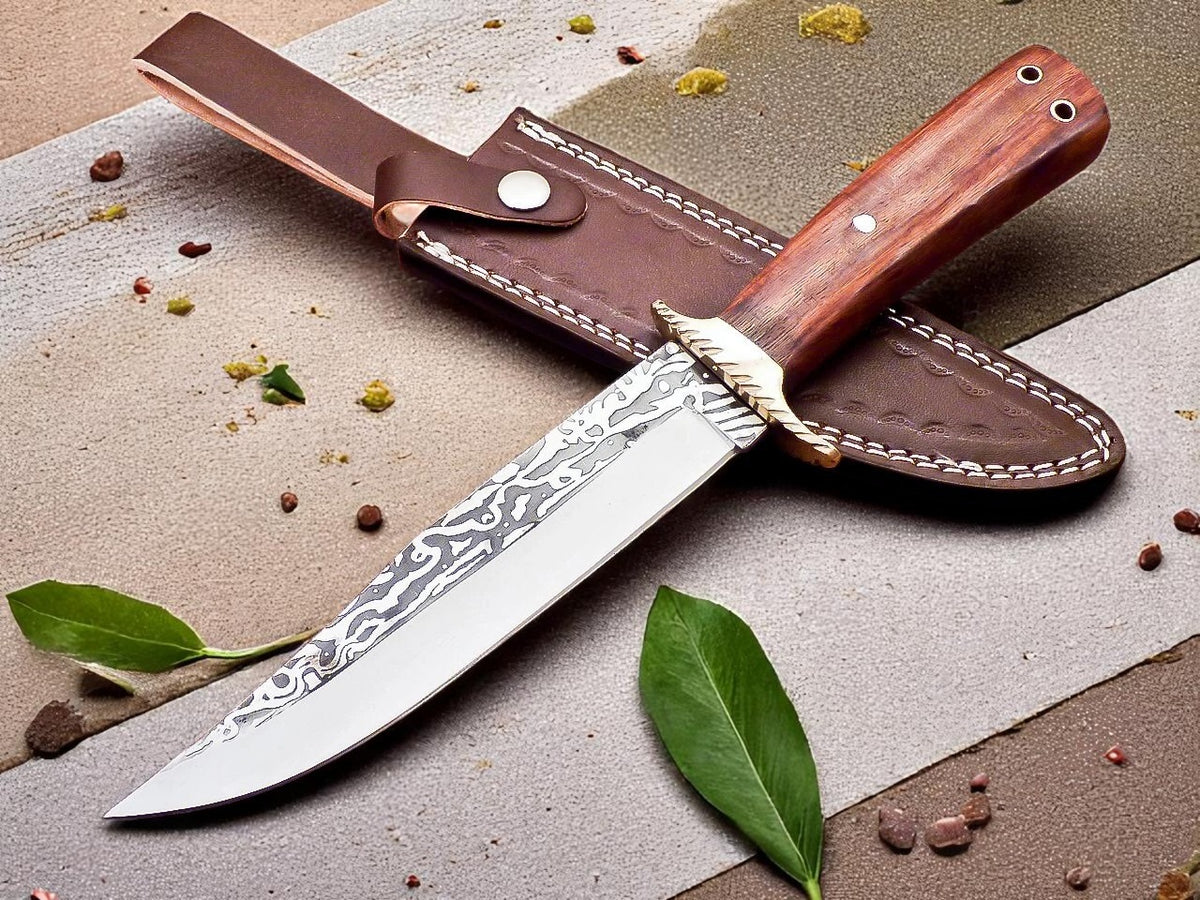Decorative knife with wooden handle and leather sheath on stone surface.