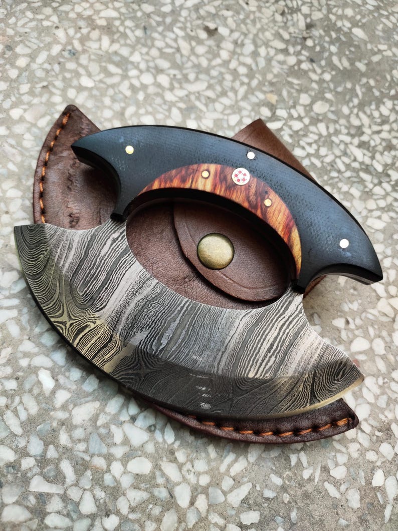 Handmade Damascus steel owl hunting knife placed inside premium leather sheath