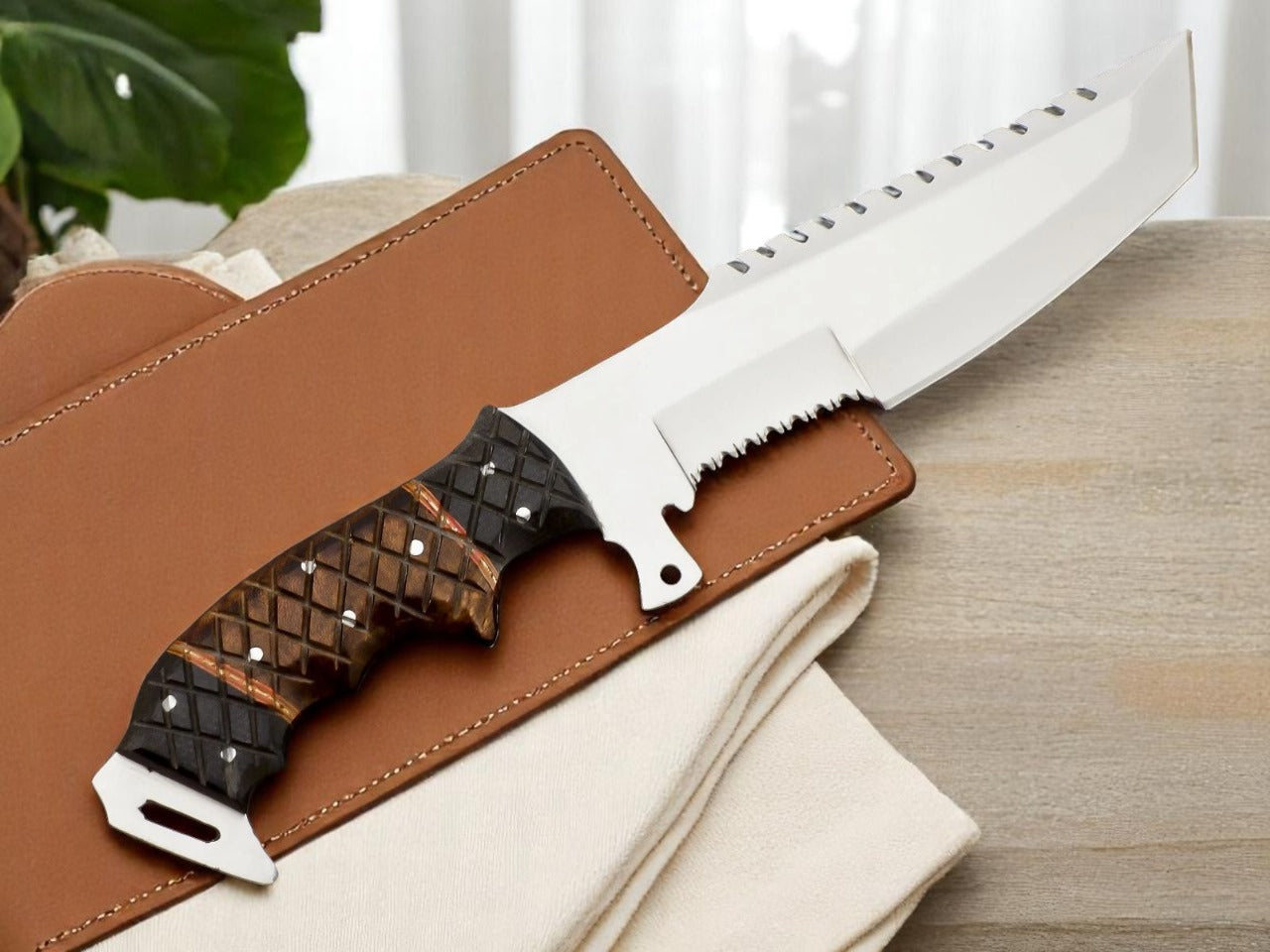 Two knives with leather sheaths on a wooden surface.