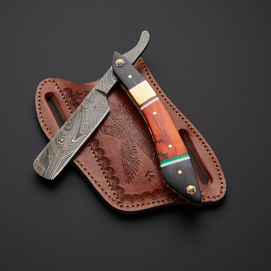 A straight razor with a Damascus steel blade and a multi-colored wooden handle, resting on its brown embossed leather sheath against a dark background.