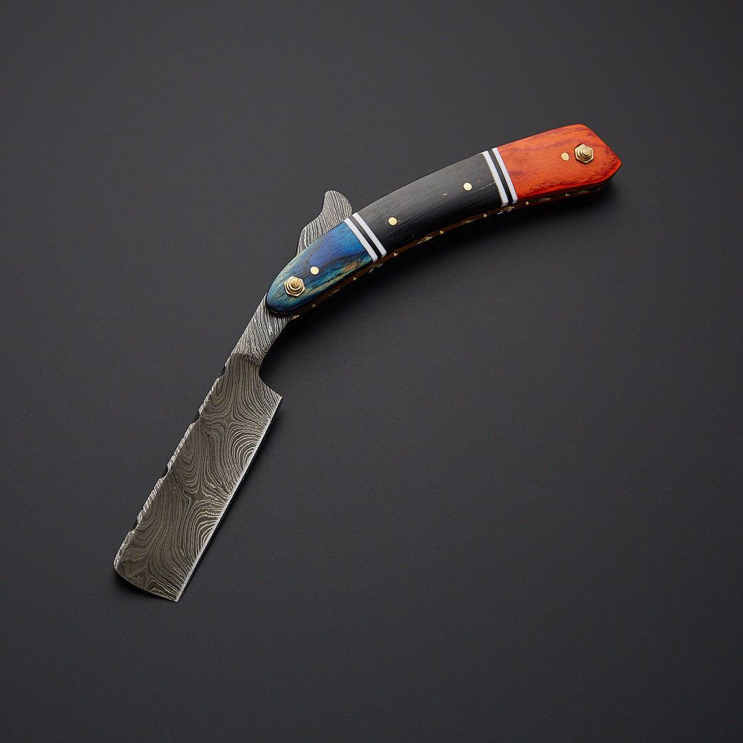Damascus steel straight razor blade showing unique wave pattern and precision-sharpened edge for smooth shaving.