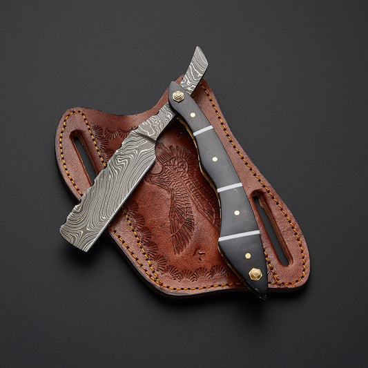 Handmade Damascus steel straight razor with sharp edge blade and elegant handle designed for professional barber shaving.
