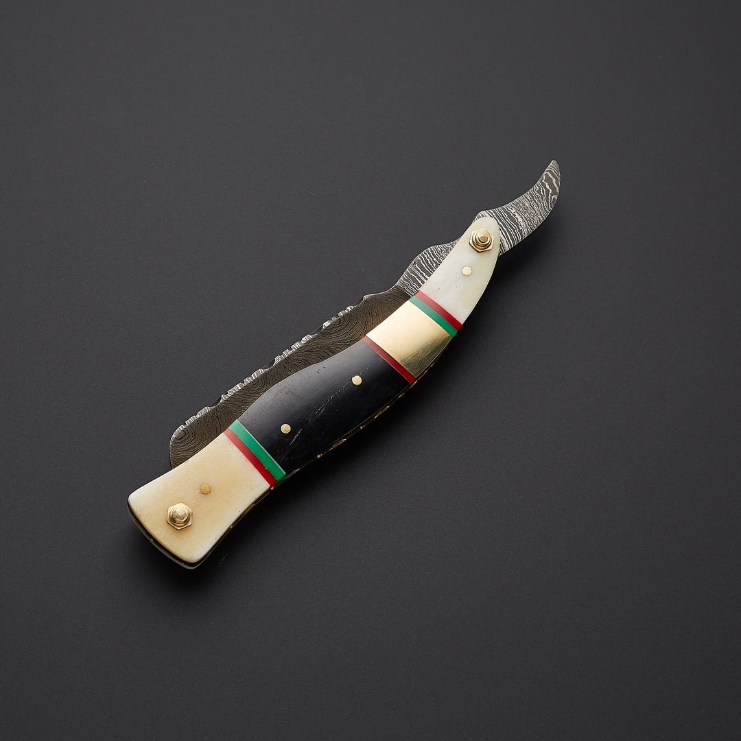 Professional straight edge razor displayed in both open and closed positions showing folding mechanism and craftsmanship details.