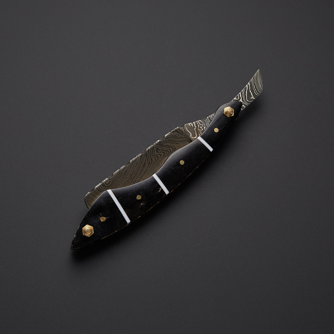 Handmade straight razor shown in open and closed positions highlighting folding design and premium metal craftsmanship.