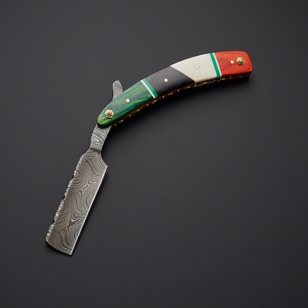 Damascus steel straight razor blade showing unique wave pattern and ultra-sharp cutting edge for precision shaving.