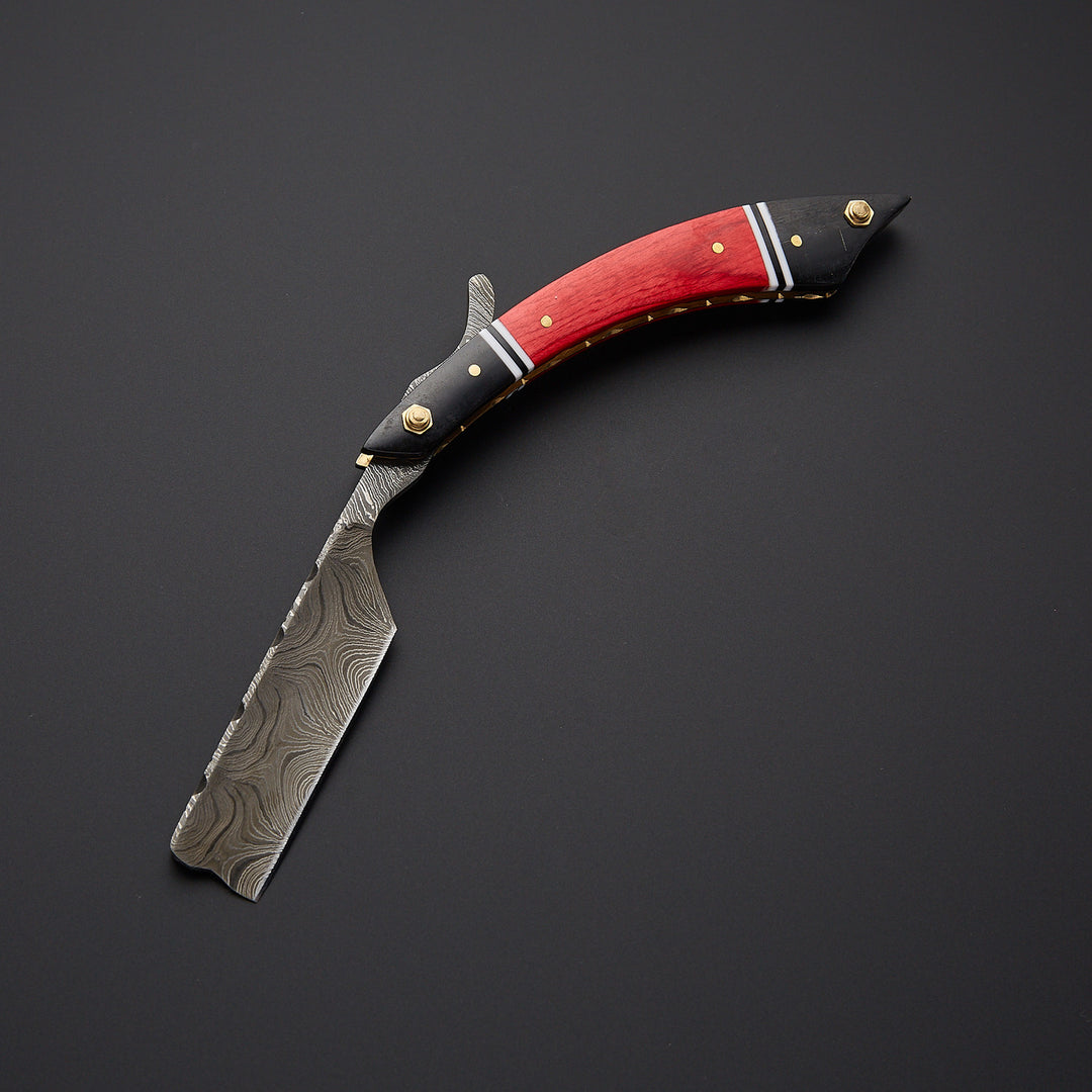 Damascus steel straight razor blade highlighting unique wavy Damascus pattern and razor-sharp edge.