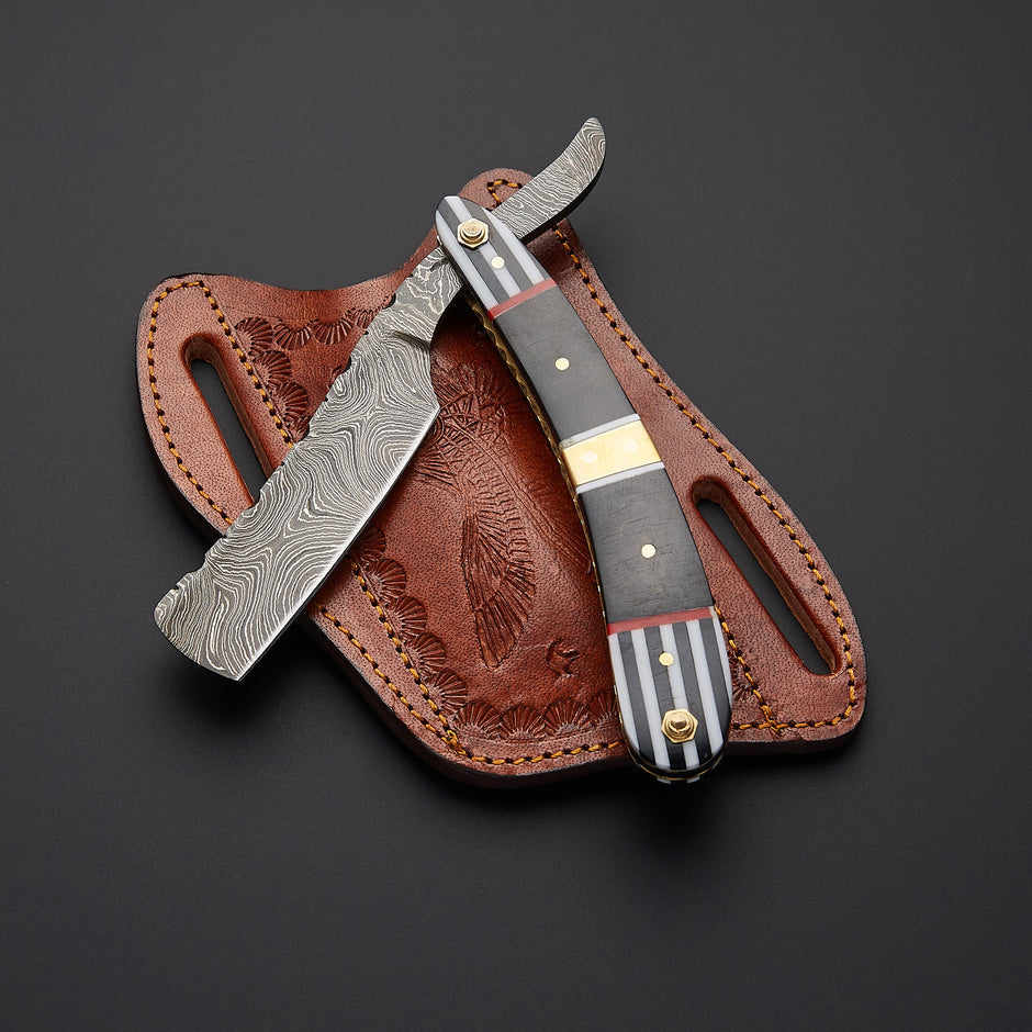Handcrafted Damascus steel barber razor with ultra-sharp straight edge blade and refined handle designed for professional wet shaving.